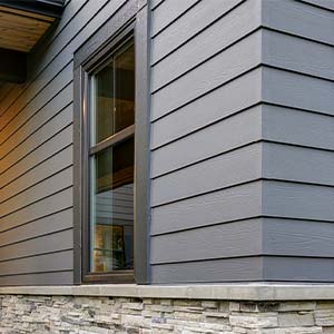 House with Gray Blue Vinyl Siding and stone siding - Click to view siding options